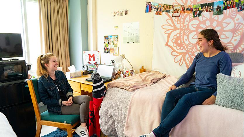 Image of students talking in dorm